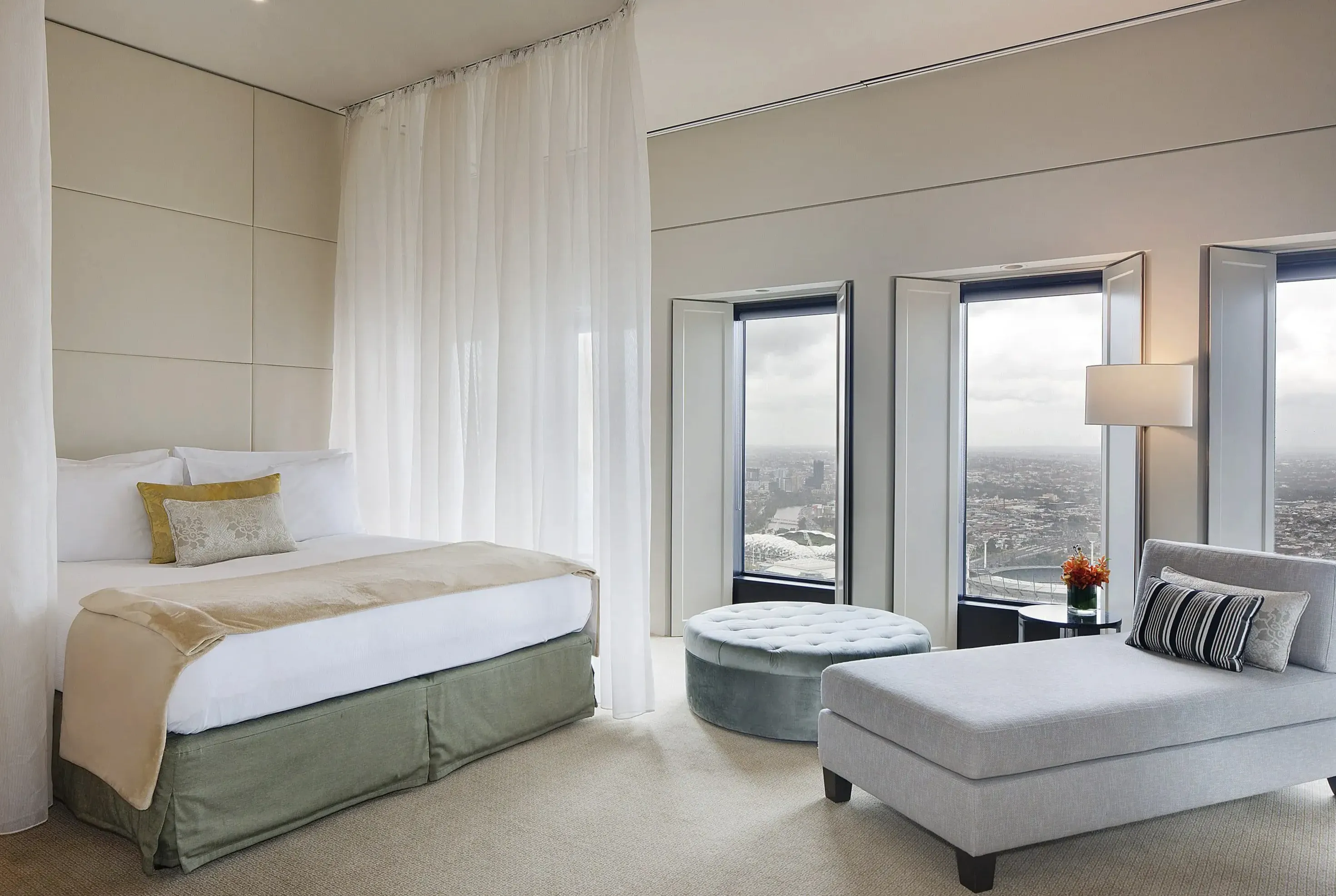 Deluxe room with king bed and floor-to-ceiling windows with city views